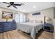 Comfortable bedroom with wood-look flooring and calming neutral decor and furniture at 3085 Vest Rd, St Cloud, FL 34772
