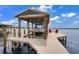 Boat house and boat on a covered dock with red chairs at 3085 Vest Rd, St Cloud, FL 34772