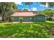 Side view of home, showcasing the large lawn, mature trees, and exterior features at 3085 Vest Rd, St Cloud, FL 34772