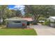 Charming single-story home with mature trees, lush lawn, and a long driveway at 3085 Vest Rd, St Cloud, FL 34772