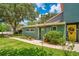 Exterior view highlighting the home's walkway, colorful door, well-maintained lawn and landscaping at 3085 Vest Rd, St Cloud, FL 34772
