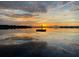 Amazing view of sunrise and clouds reflecting on tranquil lake at 3085 Vest Rd, St Cloud, FL 34772