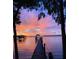 Beautiful sunset reflecting on lake with a long wooden pier at 3085 Vest Rd, St Cloud, FL 34772