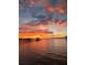 Stunning sunset over the lake with multiple docks and boat houses at 3085 Vest Rd, St Cloud, FL 34772