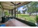 Relaxing screened porch offering outdoor seating, ceiling fan, and beautiful views of the lush landscape and water at 3085 Vest Rd, St Cloud, FL 34772