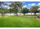 Expansive grassy yard with lake views, mature trees, and partial fencing at 3085 Vest Rd, St Cloud, FL 34772