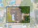 Aerial view of fenced in property showcasing a well-maintained lawn, roof, and patio at 329 Drake Elm Dr, Kissimmee, FL 34743