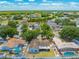 Aerial view of a home in a residential neighborhood featuring green landscaping, fencing, and nearby houses at 329 Drake Elm Dr, Kissimmee, FL 34743