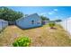 Well-maintained backyard featuring green space, partial fence, and view of rear house elevation at 329 Drake Elm Dr, Kissimmee, FL 34743
