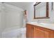 Bathroom featuring vanity with wood cabinets and tub shower with white tiles; offers comfort and functionality at 329 Drake Elm Dr, Kissimmee, FL 34743