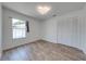 This spacious bedroom includes wood floors, a bright window, and a large closet for ample storage space at 329 Drake Elm Dr, Kissimmee, FL 34743