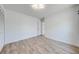 Cozy bedroom with wood-look floors, white walls, and a doorway that enhances the natural light at 329 Drake Elm Dr, Kissimmee, FL 34743