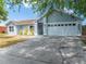 Attractive single-story home with a clean two-car garage and inviting curb appeal at 329 Drake Elm Dr, Kissimmee, FL 34743