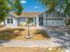 Charming single-story home featuring a well-maintained lawn and a two-car garage at 329 Drake Elm Dr, Kissimmee, FL 34743
