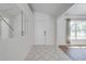 Clean entryway with tile flooring and a mirrored wall, leading to the living areas at 329 Drake Elm Dr, Kissimmee, FL 34743