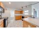 Functional kitchen with oak cabinets, and black appliances, offering a practical space for cooking at 329 Drake Elm Dr, Kissimmee, FL 34743