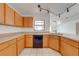 Bright kitchen with light wood cabinets, tile floor, and modern track lighting at 329 Drake Elm Dr, Kissimmee, FL 34743