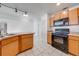 Kitchen featuring wooden cabinets and black appliances at 329 Drake Elm Dr, Kissimmee, FL 34743