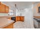 Kitchen with tile flooring, wooden cabinets, and a black dishwasher at 329 Drake Elm Dr, Kissimmee, FL 34743