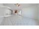 Open living area with tile flooring connects to the kitchen, dining area, and patio at 329 Drake Elm Dr, Kissimmee, FL 34743