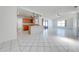 Bright open living area featuring tile flooring and an adjacent kitchen space at 329 Drake Elm Dr, Kissimmee, FL 34743