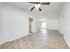 Open-concept living area with wood-look flooring and a ceiling fan, connecting to the kitchen at 329 Drake Elm Dr, Kissimmee, FL 34743