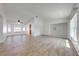 Bright and airy living room featuring wood-look floors and lots of natural light from the large windows at 329 Drake Elm Dr, Kissimmee, FL 34743