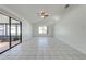 Open living room featuring large windows, a ceiling fan, and tiled floors that provide ample natural light at 329 Drake Elm Dr, Kissimmee, FL 34743