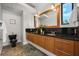 Bright bathroom with a double vanity, a large mirror, and unique stone floors at 356 S Osceola Ave # 19, Orlando, FL 32801