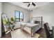 Bright bedroom featuring a comfortable bed, a large window, and a full-length mirror at 356 S Osceola Ave # 19, Orlando, FL 32801