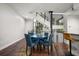 Elegant dining area with a round table, stylish chairs, and modern staircase at 356 S Osceola Ave # 19, Orlando, FL 32801
