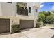 Modern home featuring a two-car garage, a balcony, and green landscaping at 356 S Osceola Ave # 19, Orlando, FL 32801