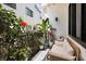 Cozy patio with a patterned rug, outdoor seating, and vibrant flowers along the decorative fence at 356 S Osceola Ave # 19, Orlando, FL 32801