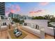Outdoor rooftop deck featuring stylish patio furniture with beautiful sunset views at 356 S Osceola Ave # 19, Orlando, FL 32801