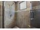 Walk-in shower featuring brown tiles with a glass door and showerhead at 356 S Osceola Ave # 19, Orlando, FL 32801