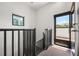 Staircase area featuring a black metal railing, a window, and an entry door at 356 S Osceola Ave # 19, Orlando, FL 32801