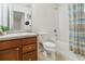 Bright bathroom featuring a single sink vanity and a shower-tub combo with tiled walls at 3566 Southern Cross Loop, Kissimmee, FL 34744