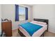 Cozy bedroom featuring a bed, dresser, and window with blue curtains at 3566 Southern Cross Loop, Kissimmee, FL 34744