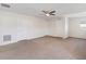 A spacious bonus room with neutral carpet, ceiling fan and lots of natural light from the window at 3566 Southern Cross Loop, Kissimmee, FL 34744