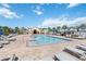 Inviting community pool with sun loungers, perfect for relaxing and enjoying sunny days at 3566 Southern Cross Loop, Kissimmee, FL 34744