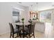 Cozy dining area with a glass table and view of the backyard at 3566 Southern Cross Loop, Kissimmee, FL 34744