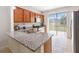 Modern kitchen featuring granite countertops, stainless steel appliances, and outdoor access at 3566 Southern Cross Loop, Kissimmee, FL 34744