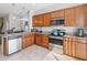 Well-equipped kitchen with modern appliances, granite countertops, and tile flooring at 3566 Southern Cross Loop, Kissimmee, FL 34744