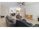 Open-concept living room with tile floors that flows into the kitchen and dining area at 3566 Southern Cross Loop, Kissimmee, FL 34744