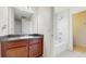 Bathroom featuring wood vanity, vanity mirror, tiled shower and tub combo with contemporary lighting for functionality at 4002 Scarlet Branch Rd, Orlando, FL 32824