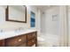Modern bathroom featuring white marble tile shower and bathtub with wooden vanity cabinet for a luxurious feel at 4002 Scarlet Branch Rd, Orlando, FL 32824