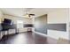 Contemporary bedroom with stylish two-tone walls, ceiling fan, and dark laminate floors offering a sleek aesthetic at 4002 Scarlet Branch Rd, Orlando, FL 32824