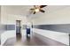 Open bedroom featuring two-tone walls, ceiling fan, and dark laminate floors offering a spacious walk-in closet at 4002 Scarlet Branch Rd, Orlando, FL 32824