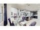 Open dining and kitchen area with a large glass table and seating for six at 4002 Scarlet Branch Rd, Orlando, FL 32824
