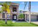 Elegant two-story home boasting a stone facade, attached garage, and well-manicured lawn at 4002 Scarlet Branch Rd, Orlando, FL 32824